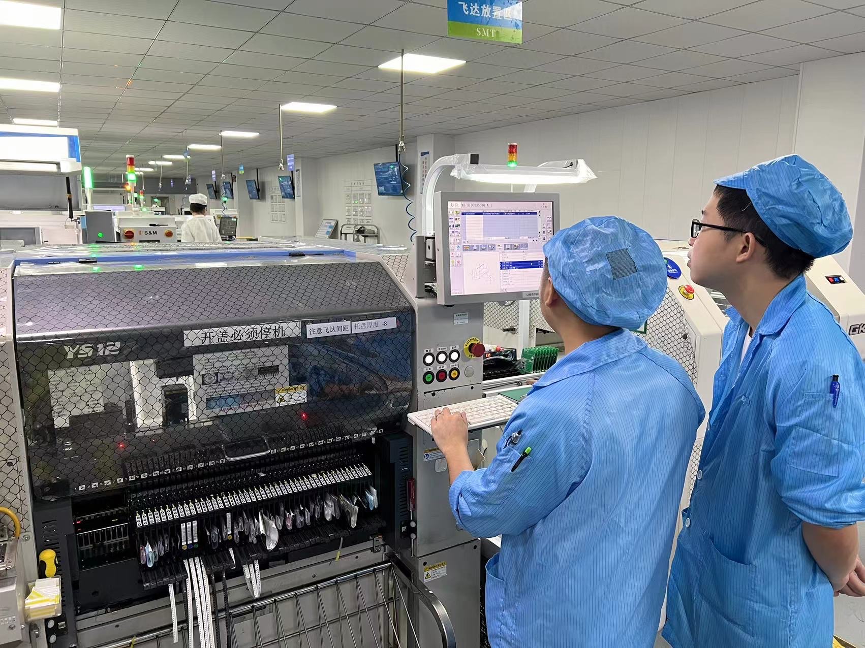 echnicians working in a clean, organized factory environment focused on PCB assembly, highlighting precision, quality control, and key steps in the electronics manufacturing process.